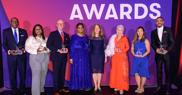 Alumni Awards recipients, alongside LaTanya Sothern and Sylvia Burwell, pose with crystal eagles