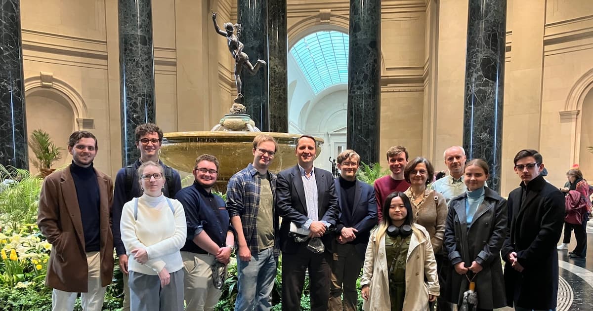 The tour group in the National Gallery of Art's foyer, in front of a fountain.