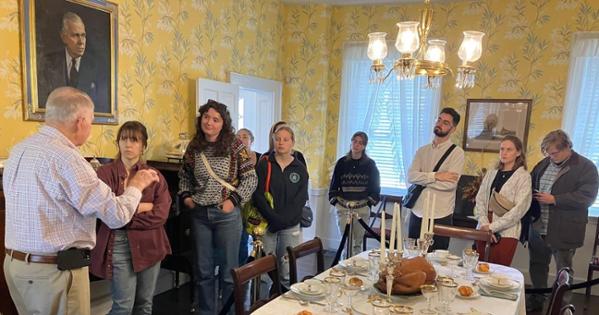 Students hear guide explain General Marshall's legacy in the dining room.