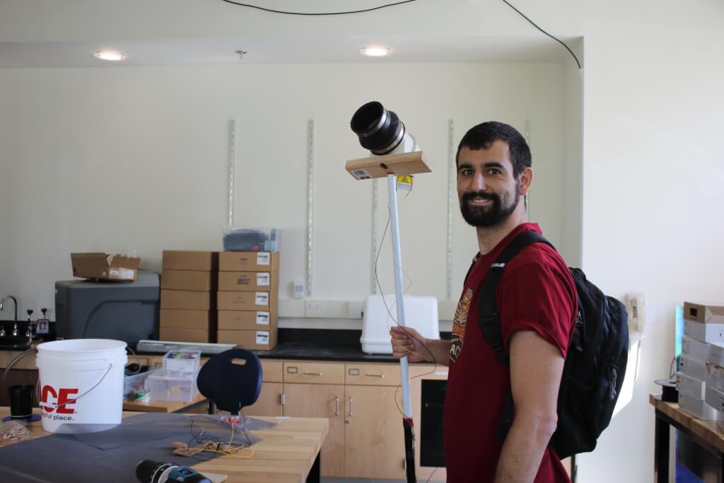 Brendan Riske holding mosquito aspirator device