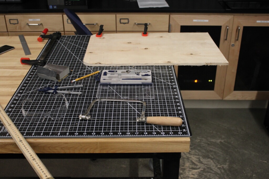 Workspace with woodworking tools and cut board