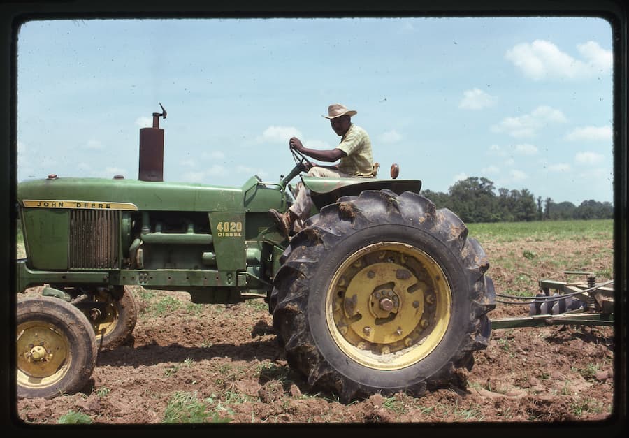 Vintage photo of man on tractor, Photo courtesy of the FSC/LAF Black farmer archives