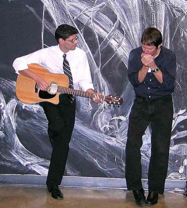 Dave Keplinger plays guitar while Kermit Moyer plays harmonica