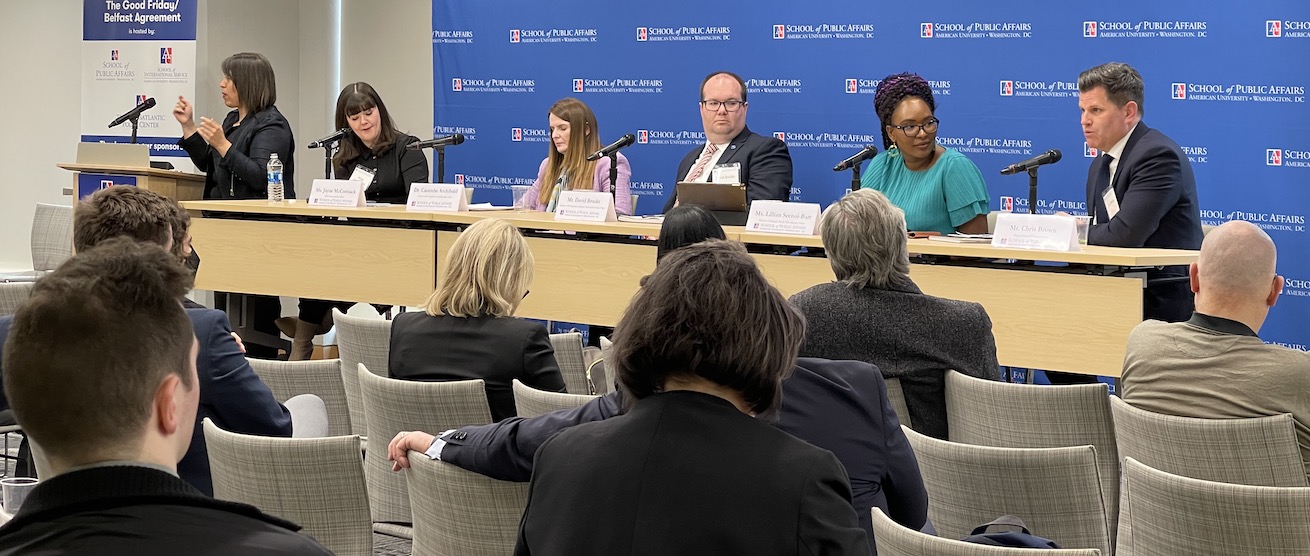 A panel discussion in front of an audience.