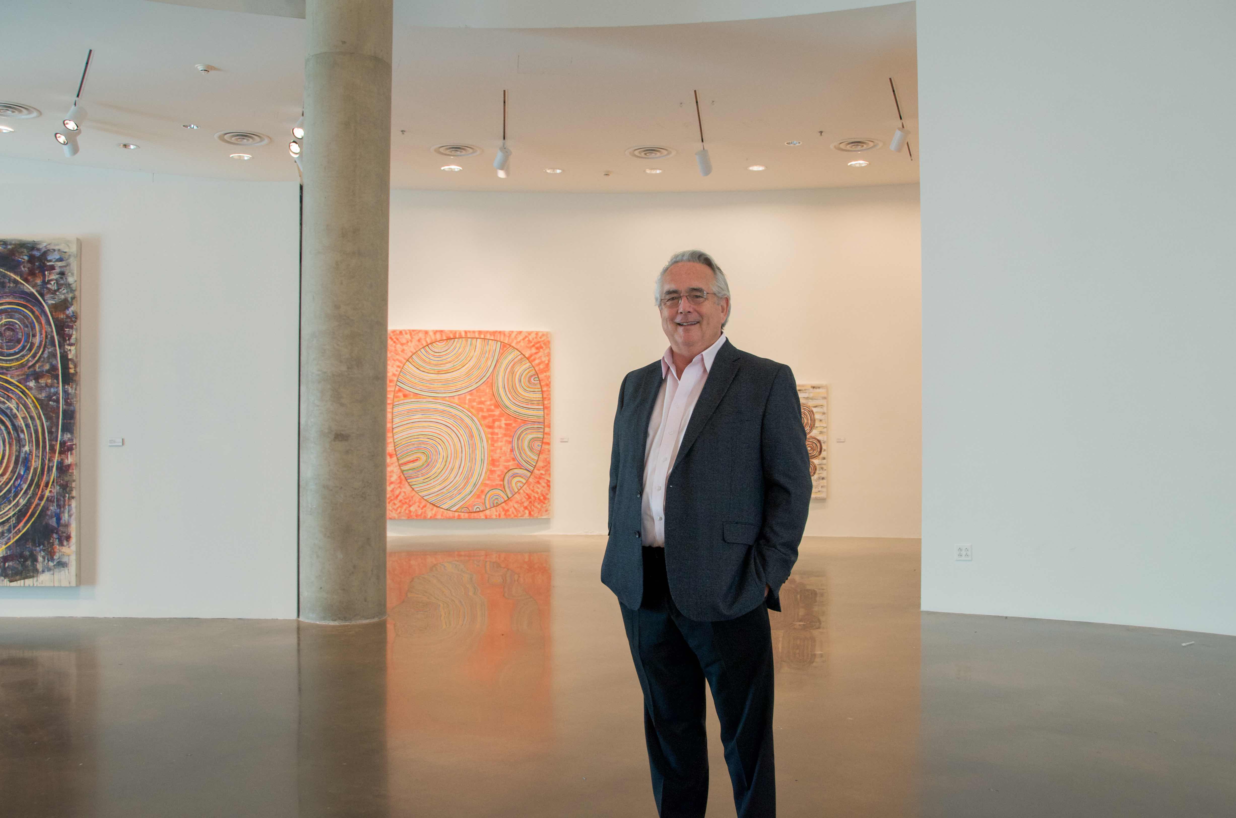 Jack Rasmussen standing among artworks in the AU Museum in Katzen Performing Arts Center.