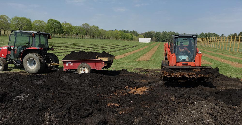 Tractors shoveling compost at Airlie