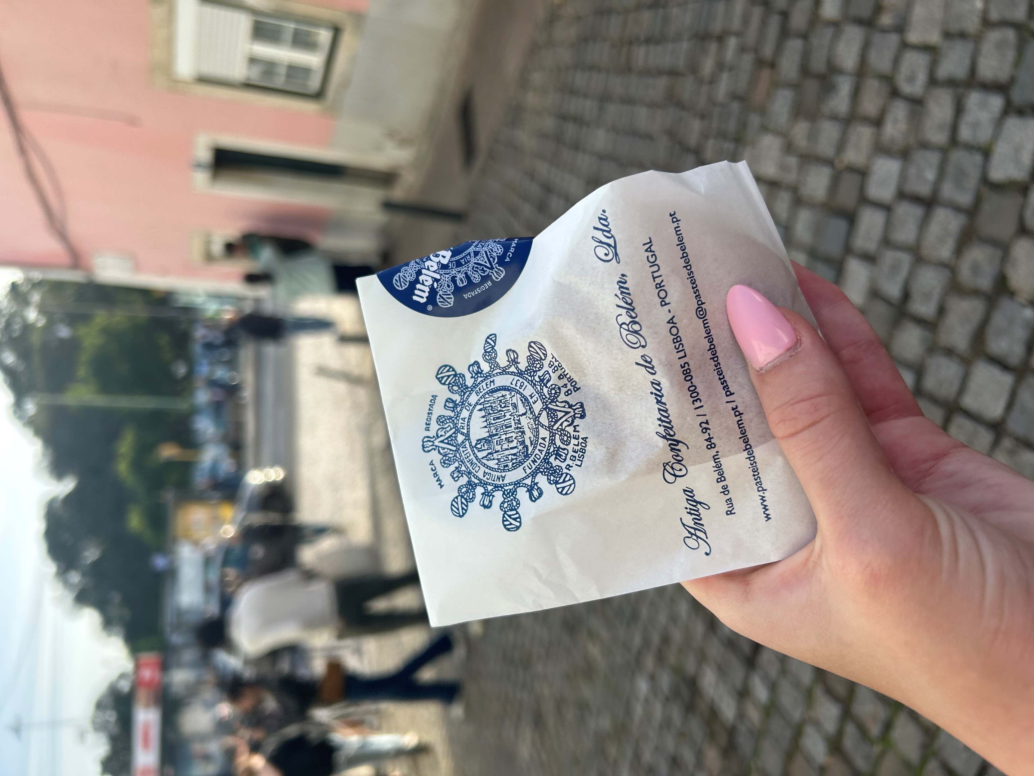 woman holding pasteles de nata in Lisbon