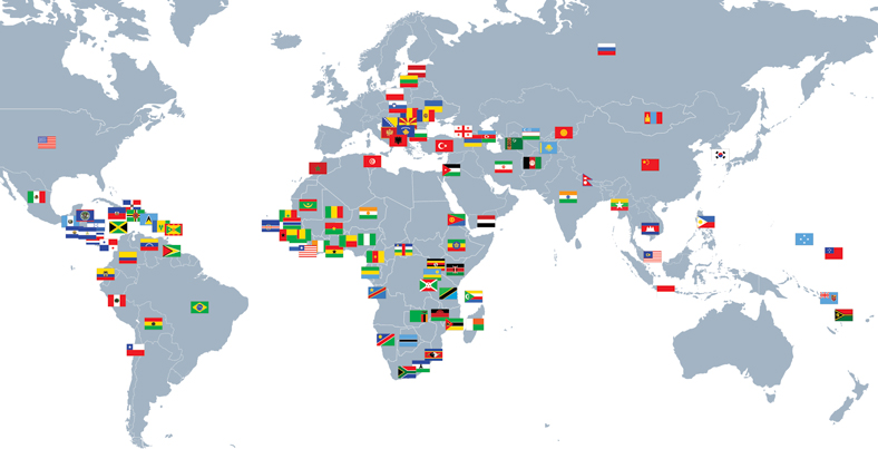 map of the world with flags marking the 107 countries where AU grads have served