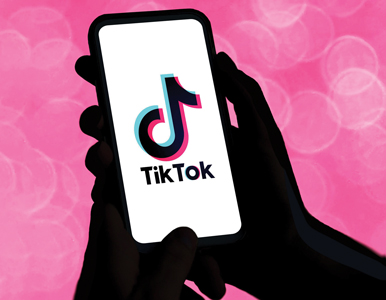 hand holding a phone with TikTok