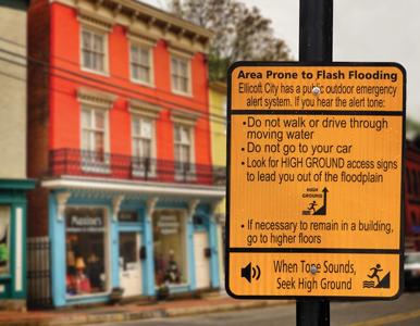 a street sign touting flood risk in Ellicott City, Maryland