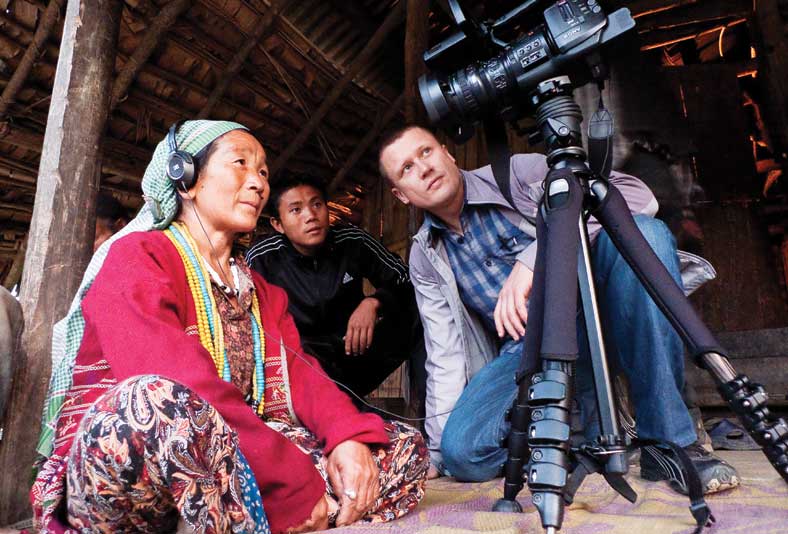 Abamu Degio watches a recording of herself singing a traditional Koro song.