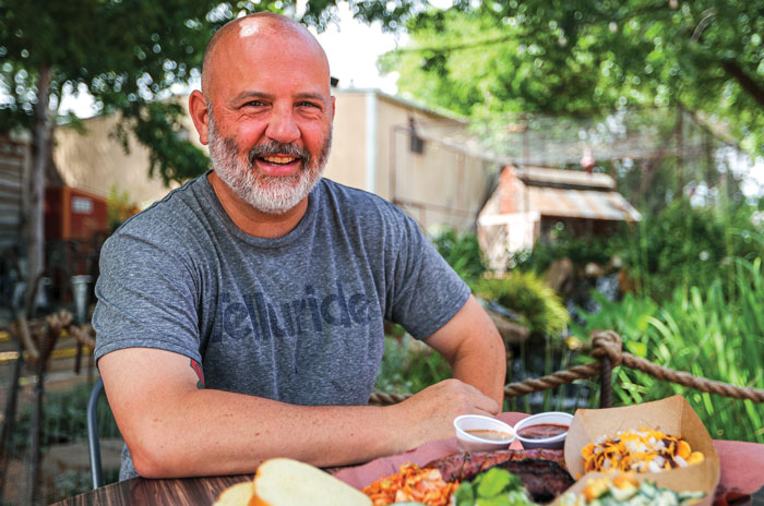 Matthew Odam sits outside before a big plate of food