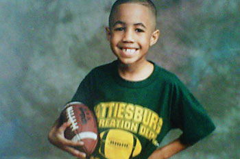 Deon Jones as a little kid, holding a football