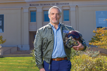 Joseph Mortati stands in front of the Kogod School of Business in Air Force flight jacket