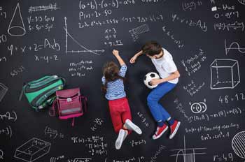 kids doing math problems on a chalkboard