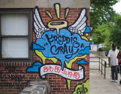 brick wall with graffiti that says "Freddie Gray RIP"