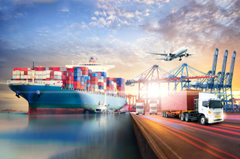 A truck leaves a shipping port with construction crane in background