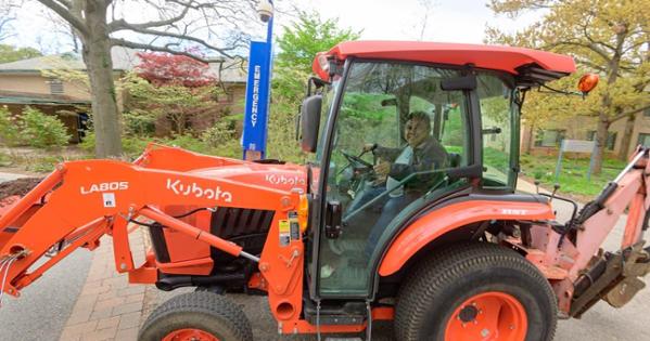 An AU staff member drives a tractor on Campus Beautification Day. Photo by Jeff Watts. 