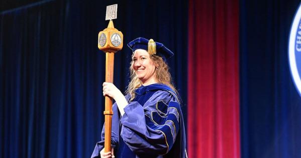 Jenny Axe carries the academic mace at fall 2024 commencement. Photo by Jeff Watts.