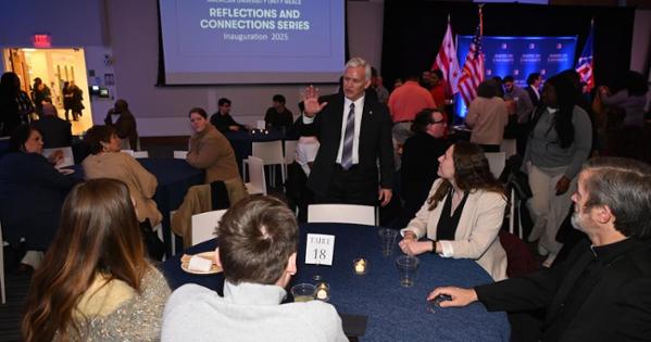 President Jon Alger greets attendees at the Unity Meal held at WCL's Claudio Grossman Hall.