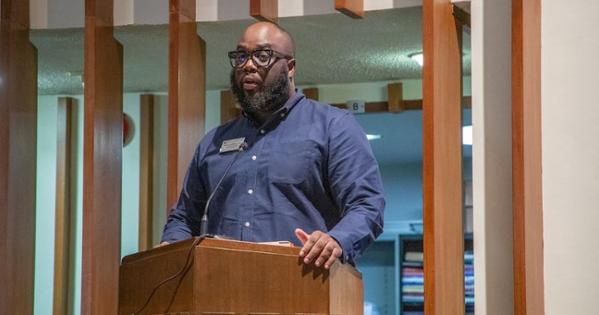 Dayne Hutchinson speaks at the Black History Month event. Photo by Julia Gibson. 