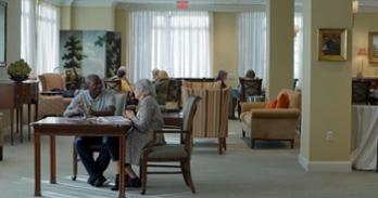 man studies for his citizenship with elders woman