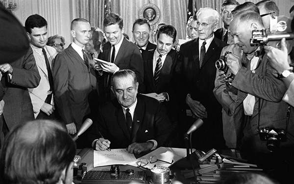 President Lyndon B. Johnson signs the Civil Rights Act of 1964. Credit: LBJ Library