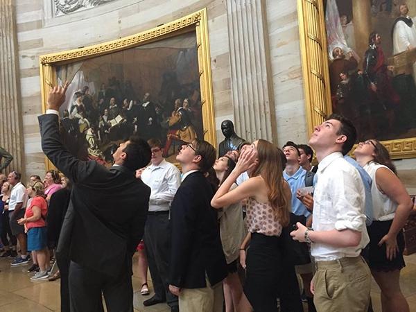 Students are led through an art gallery.