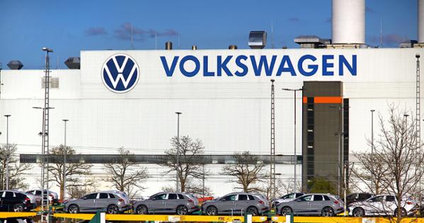 The outside of a white factory in Germany with Volkswagen written on the side