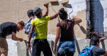 volunteers painting a wall