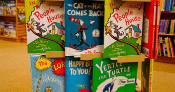 a few Dr. Seuss books on display in a bookstore - includes The Cat in the Hat, Yertle the Turtle, The Lorax.