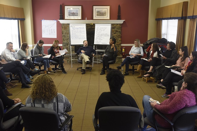 Cohort 74 seated in circle in class