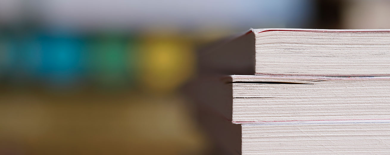 Research books stacked on table