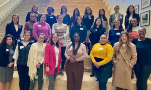 28 women in a group photo on stairs