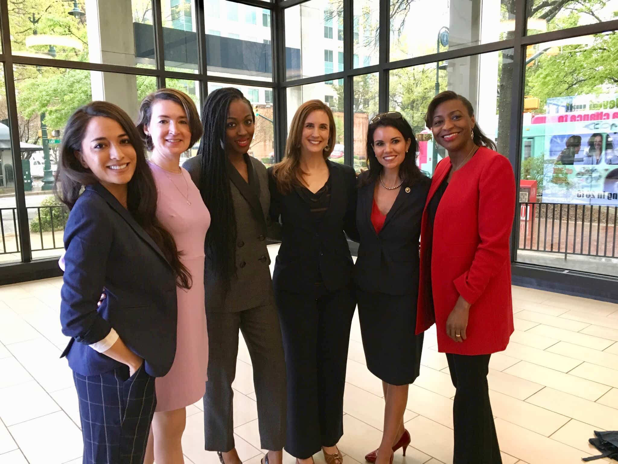 Panelists and Betsy posing at the event