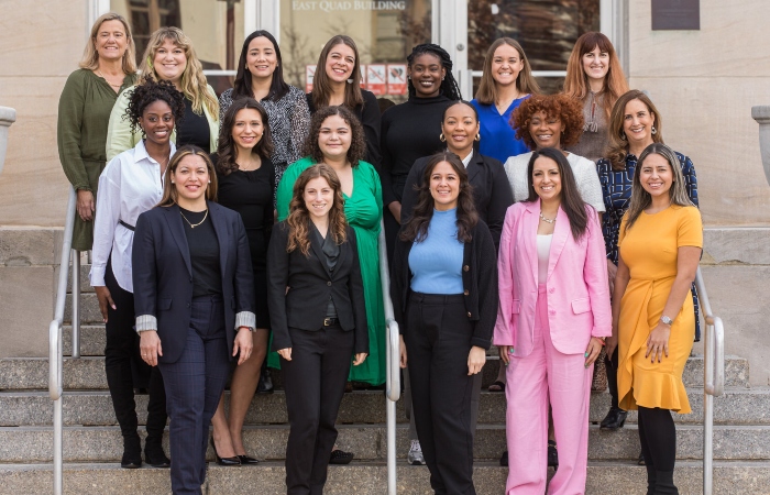 16 women graduates of welead standing outside on steps