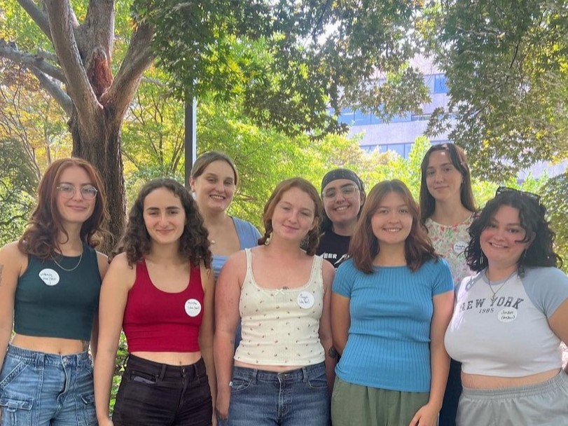 A group of students who are peer health educators pose, smiling.