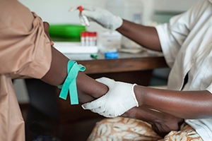 African nurse drawing blood.