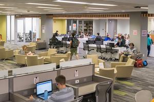 A floor in the library full of desks, chairs, tables, and study areas.