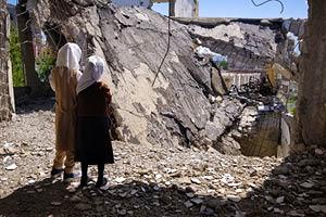 Schoolchildren stand on their destroyed school in the Yemeni city of Taiz.