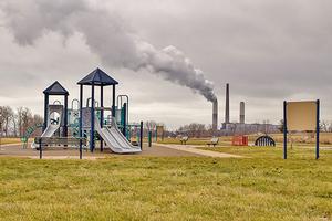 Playground with processing plant in background