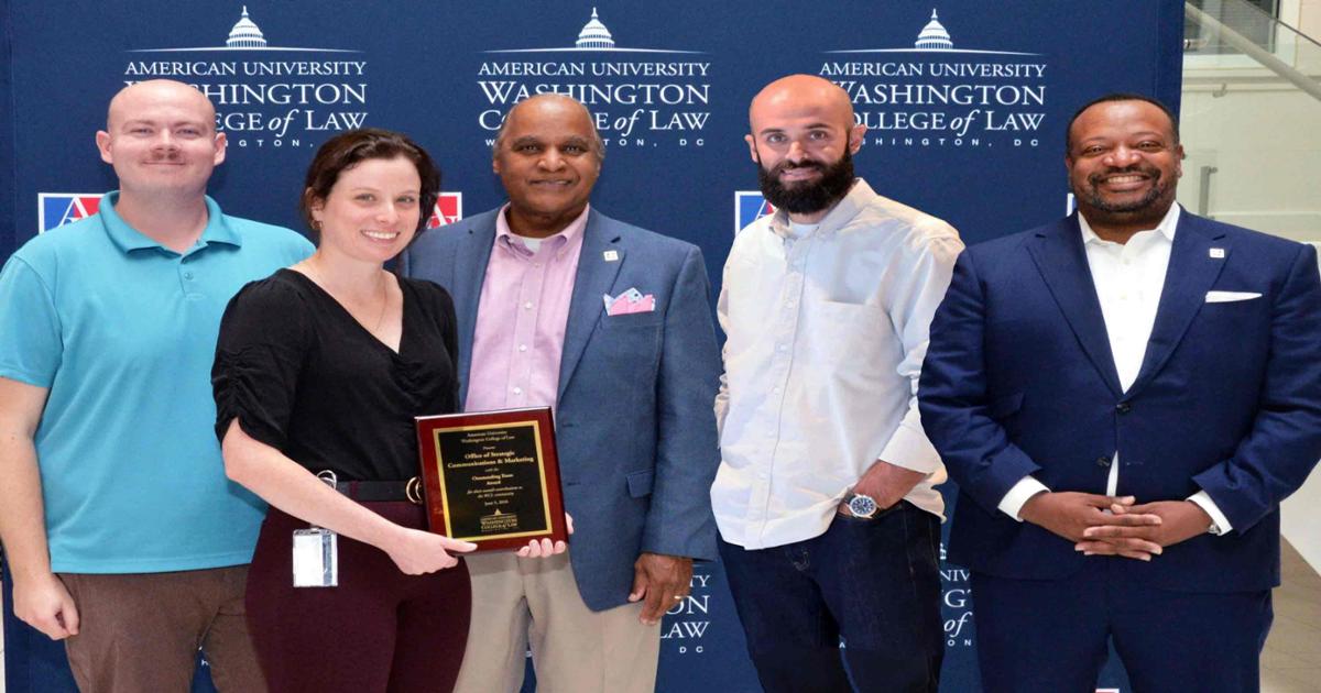 The Office of Strategic Communications and Marketing, (from left to right, Brice Helms, Liz Newton, Keith Pierce, and Erik Garcia) received the Outstanding Team Award from Dean Fairfax (right).