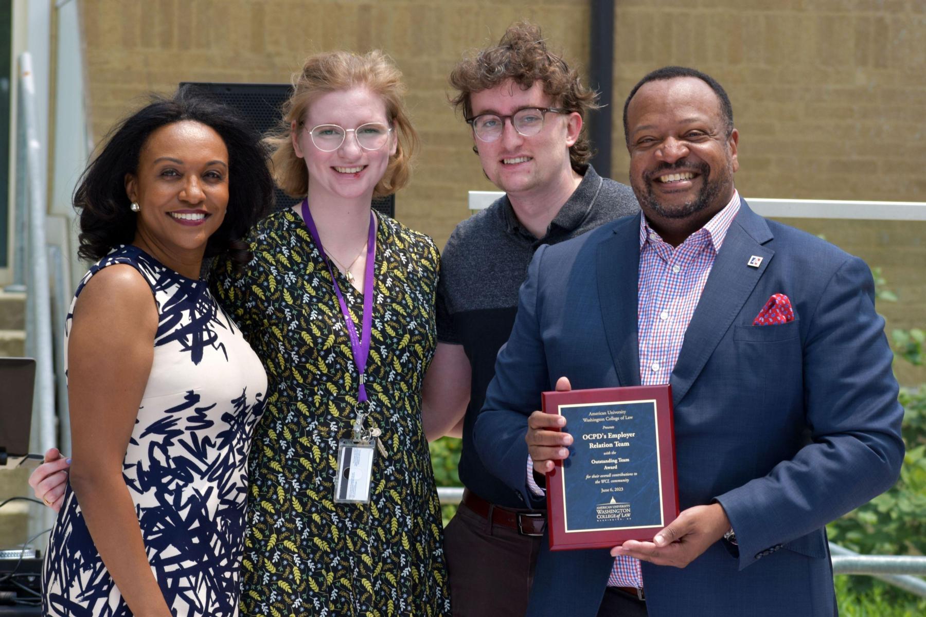 Raquel Skinner, Sam Chaplin, Rachel Cara receiving the Outstanding Team Award from Dean Fairfax