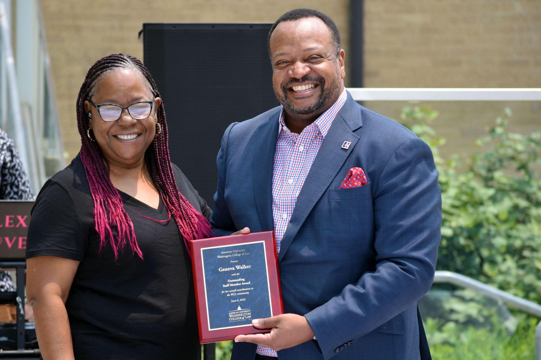 Geneva Walker receiving the Outstanding Staff Award from Dean Fairfax