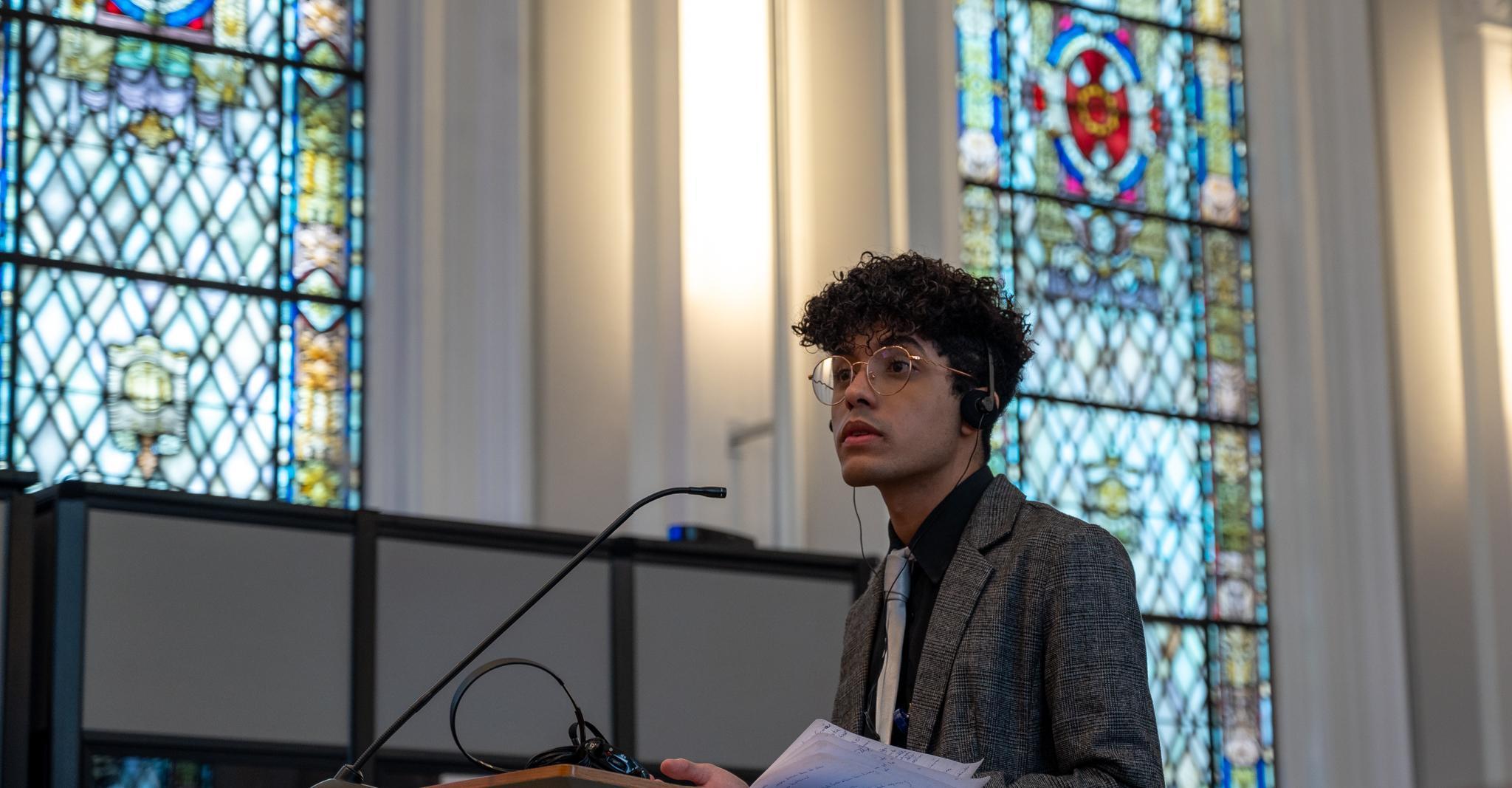 A participant in the Moot Court Competition argues their case to the panel of judges